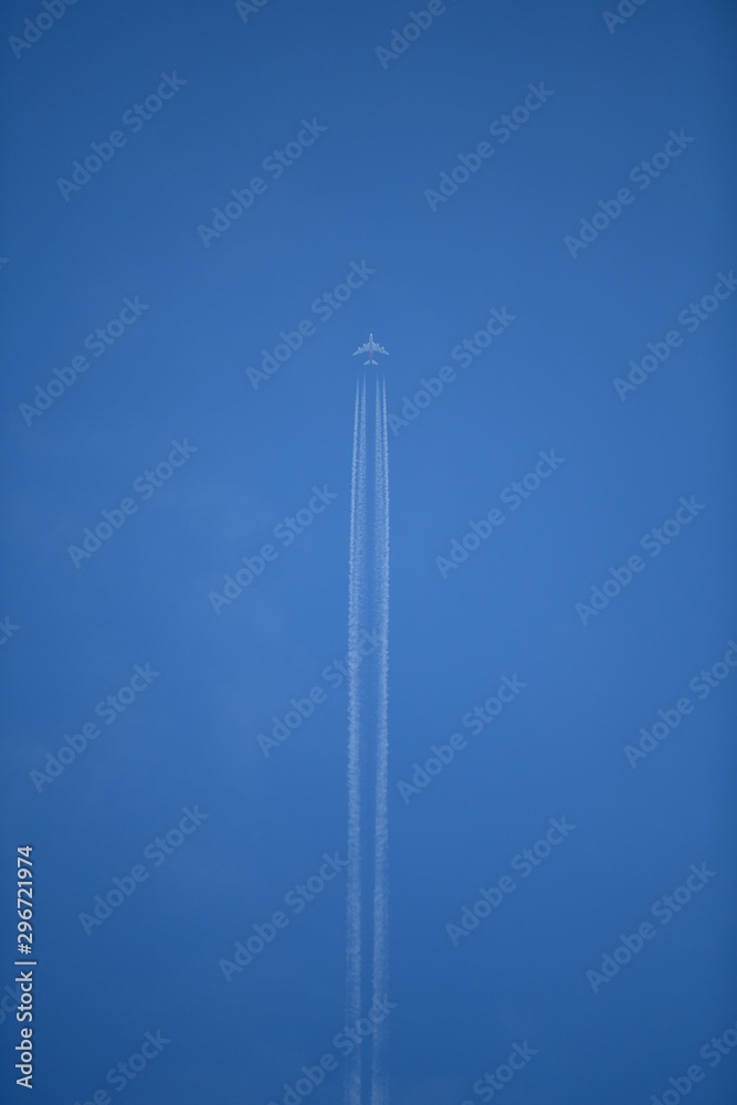 White airplane and jet engine in a blue sky White airplane and jet engine in a blue sky