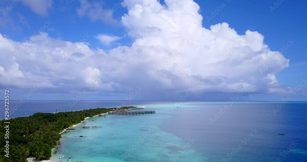 Breathtaking aerial drone view flying above a long isthmus with green vegetation and a resort with over water bungalows on the shore in the Philippines 4K Breathtaking aerial drone view flying above a long isthmus with green vegetation and a resort with over water bungalows on the shore in the Philippines 4K