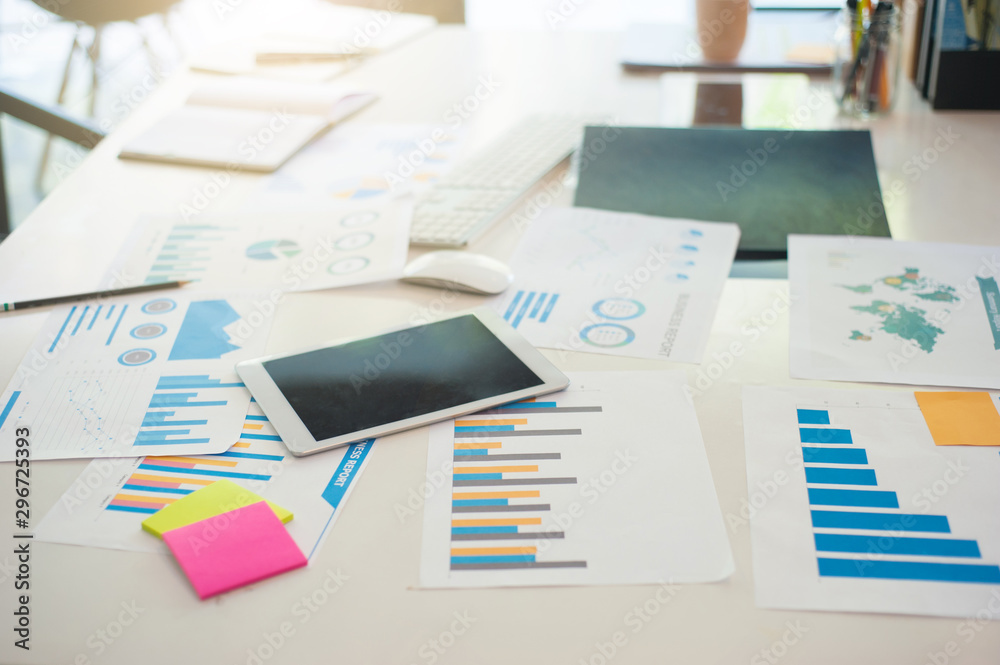 Analyst's desk is full of documents.