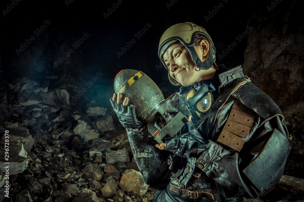 Fototapeta premium Soldier woman with the bomb on post apocalyptic background.