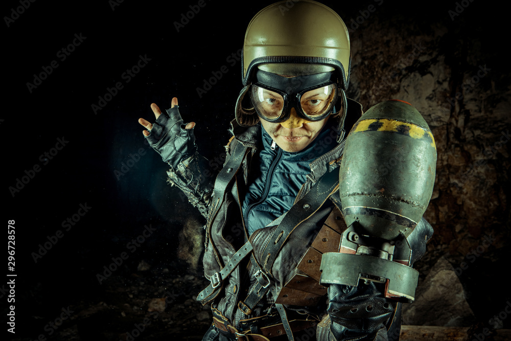 Fototapeta premium Soldier woman with the bomb on post apocalyptic background.