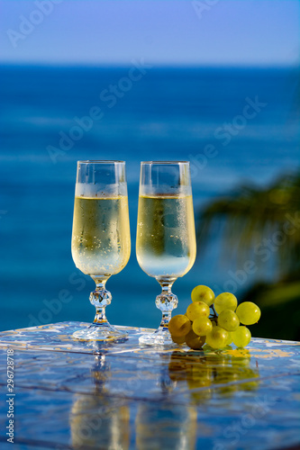 Photography Romantic event, bottle with cold sparkling wine, cava or champagne served with t