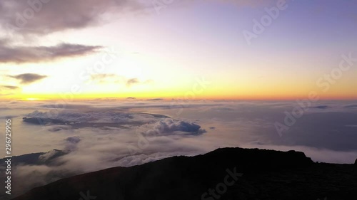 Aerial view from top of mountain Pico, revealing the Azores island with a purple twilight due to volcanic gases. photo