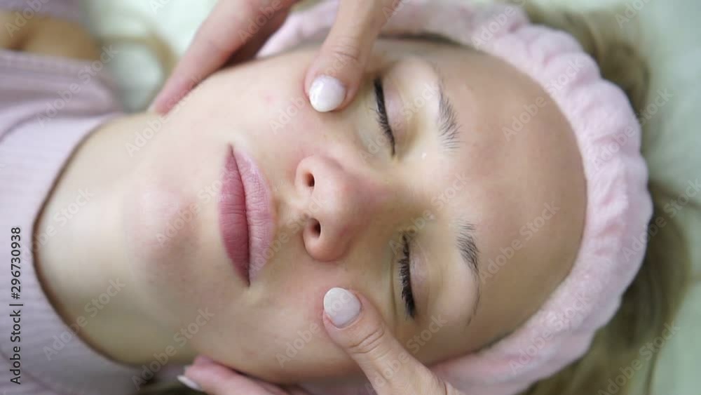 Young beautiful woman in a beauty salon, facial massage, cosmetology. Young beautiful woman in a beauty salon, facial massage, cosmetology.