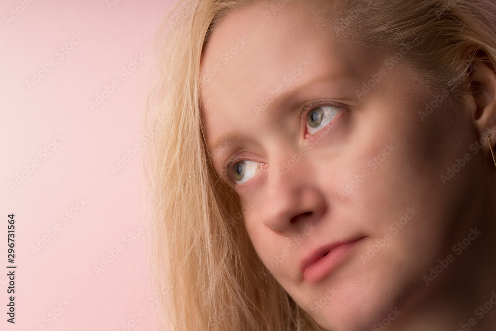 Close up portrait of cute charming  nervous beautiful attractive girl looking side . pink background 
