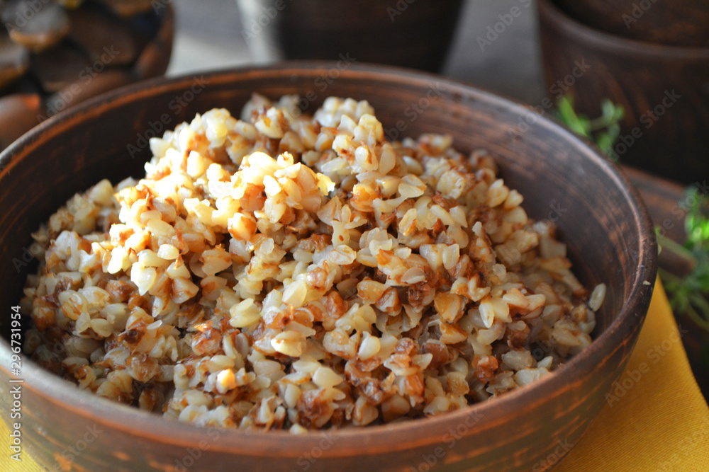 Organic buckwheat porridge in rustic ceramic bowl close up Organic buckwheat porridge in rustic ceramic bowl close up