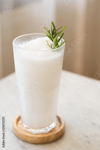 Coconut Smoothie in Glass Cup with Green Sprig