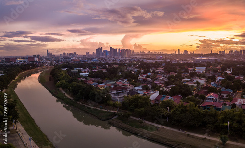 Scenic Drone Aerial Picture of the Marikina River and the Skyline of Eastwood City during Sunset in Metro Manila, Philippines photo