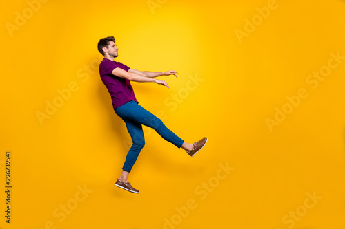 Full length body size side profile photo of kicked man having been fired away from job flying back isolated over yellow vivid color background