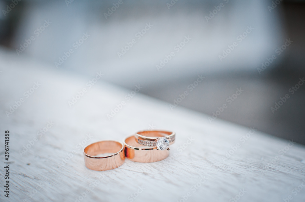 Pair of gold wedding rings on the white marble Pair of gold wedding rings on the white marble
