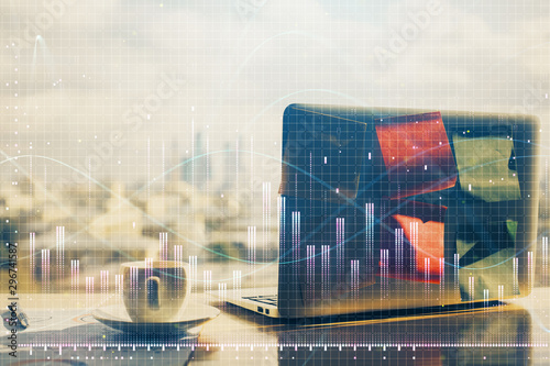 Double exposure of graph and financial info and work space with computer background. Concept of international online trading.