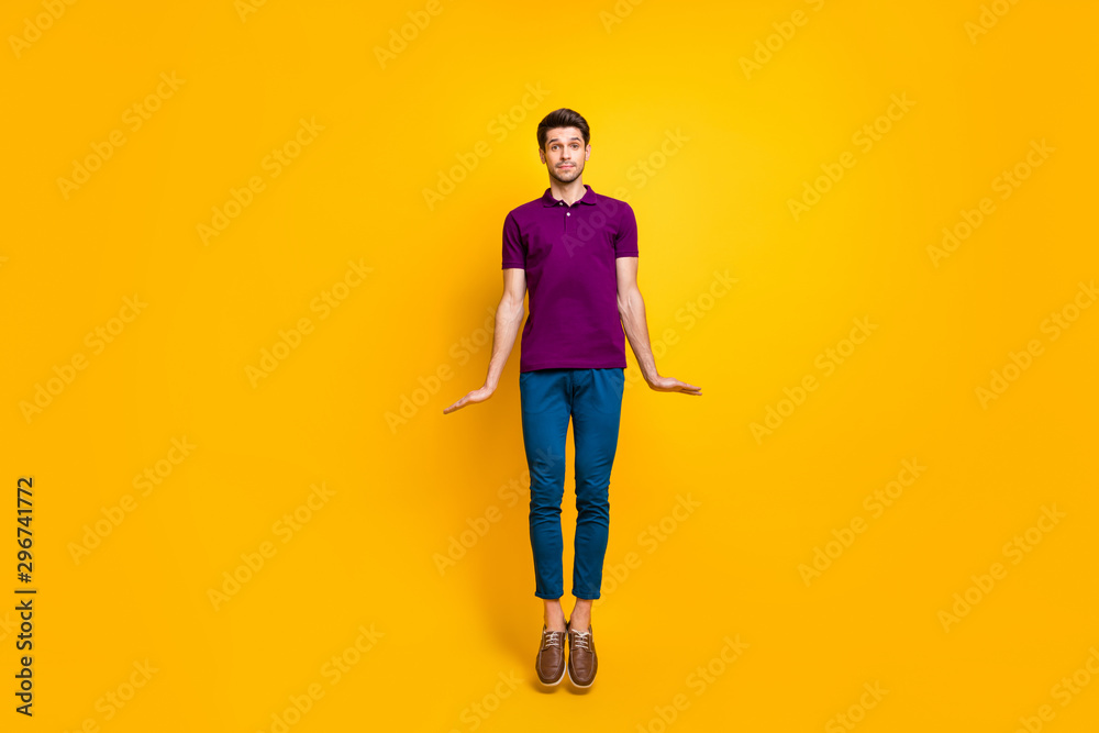 Full length body size view of his he nice attractive funny playful childish guy jumping up isolated over bright vivid shine vibrant yellow color background Full length body size view of his he nice attractive funny playful childish guy jumping up isolated over bright vivid shine vibrant yellow color background