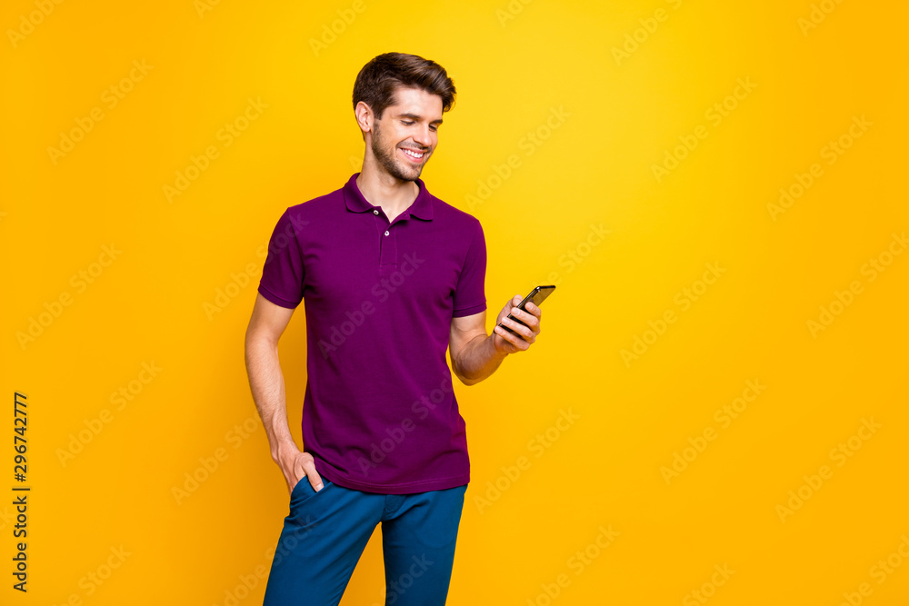 Portrait of his he nice attractive content cheerful cheery glad guy wearing violet shirt using gadget sharing repost smm like isolated on bright vivid shine vibrant yellow color background Portrait of his he nice attractive content cheerful cheery glad guy wearing violet shirt using gadget sharing repost smm like isolated on bright vivid shine vibrant yellow color background