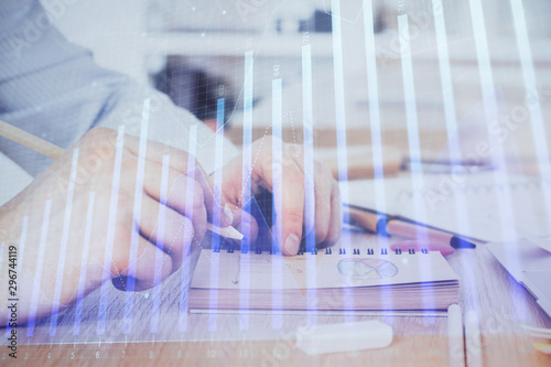 Multi exposure closeup hands with stock market forex graph.