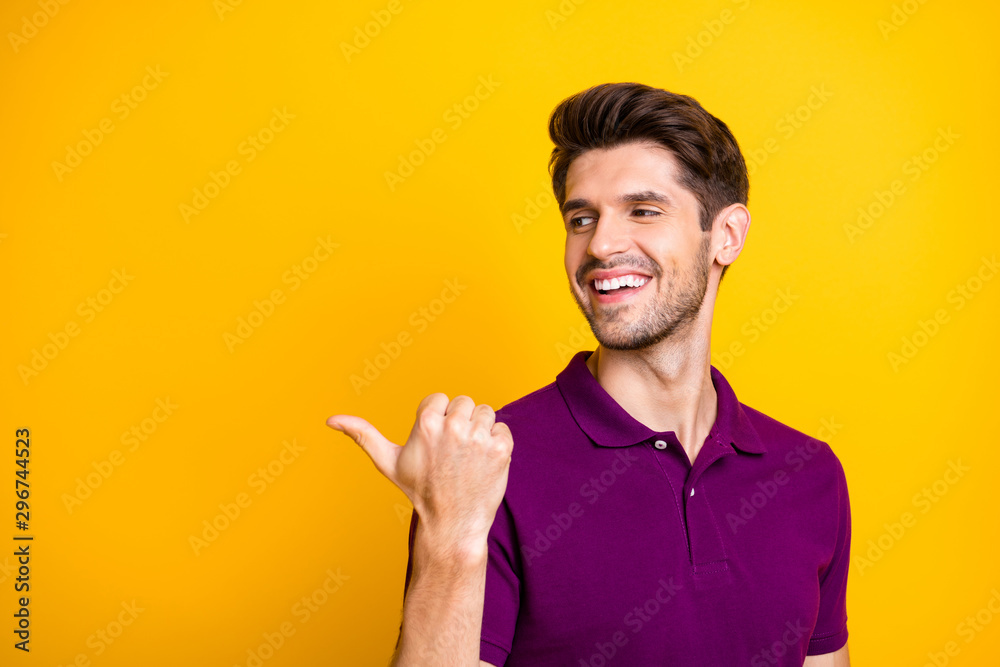 Close-up portrait of his he nice attractive content cheerful glad guy wearing lilac shirt pointing thumb aside decision solution like isolated on bright vivid shine vibrant yellow color background Close-up portrait of his he nice attractive content cheerful glad guy wearing lilac shirt pointing thumb aside decision solution like isolated on bright vivid shine vibrant yellow color background