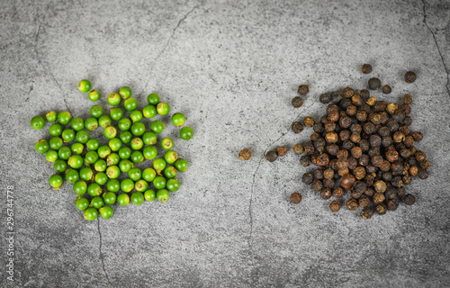 peppercorns on dark background - fresh green peppercorn and black pepper seed for ingredients cuisine thai food herbs and spices