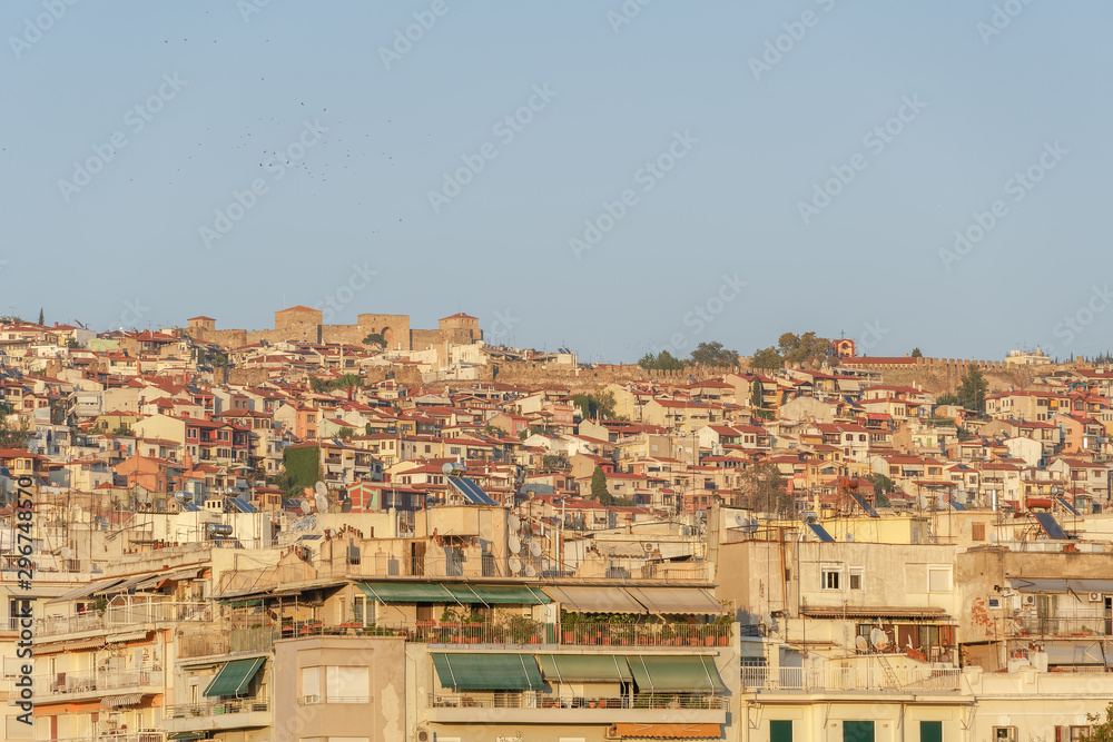 Thessaloniki, Greece Upper Town called Ano Poli golden hour view. Evening view of UNESCO Heritage listed district with traditional houses, Byzantine castles & Heptapyrgion, Yedi Kule fortress visible. Thessaloniki, Greece Upper Town called Ano Poli golden hour view. Evening view of UNESCO Heritage listed district with traditional houses, Byzantine castles & Heptapyrgion, Yedi Kule fortress visible.