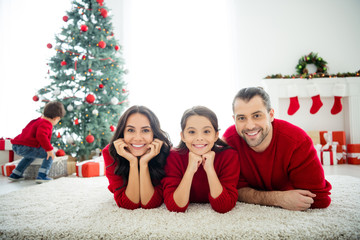 Portrait of nice attractive lovely idyllic sweet peaceful cheerful dreamy affectionate family celebrating spending newyear enjoying leisure weekend eve noel in light white interior living-room