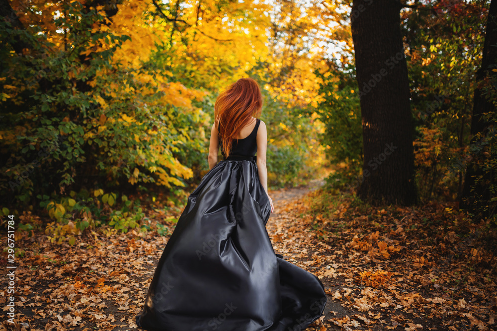girl running in autumn orange forest. Long red hair develops in the wind. girl running in autumn orange forest. Long red hair develops in the wind.