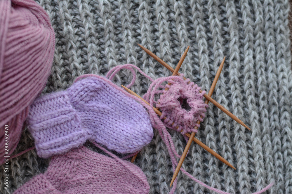 Fototapeta premium Pink and purple baby socks, made of warm and soft woolen yarn