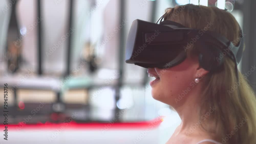 Young girl wearing virtual reality glasses expresses surprise and says Young girl wearing virtual reality glasses expresses surprise and says