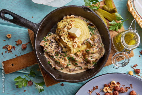 Mashed potatoes with beef in mushroom sauce and hazelnuts