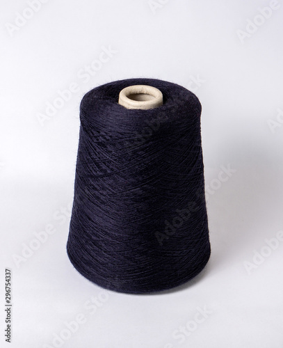 bobbin of yarn on a white background. Side view.Textile reel on isolated white background.