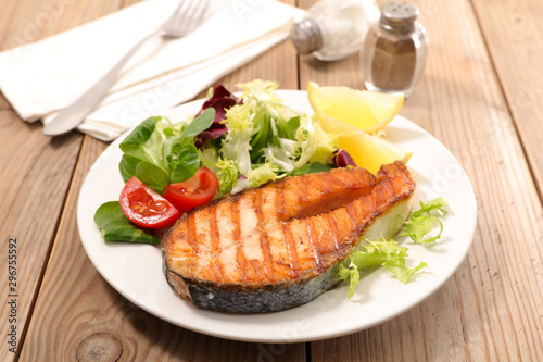 salmon steak with salad and tomato