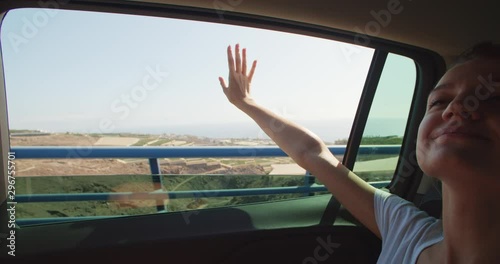 Wallpaper Mural Inspiring scenery out of window. Close-up of cheerful smiling blonde girl enjoying landscape sticking hand out of car window. Summer roadtrip. Tenerife, Spain. Torontodigital.ca