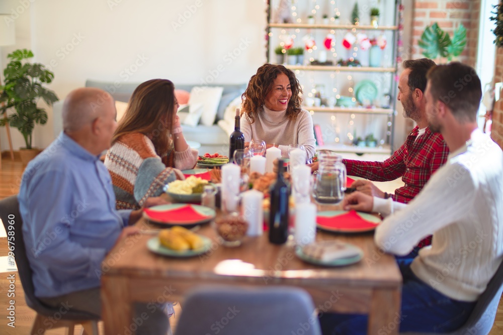 Beautiful family smiling happy and confident. Eating roasted turkey celebrating Christmas at home Beautiful family smiling happy and confident. Eating roasted turkey celebrating Christmas at home
