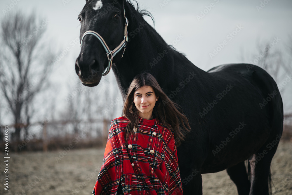 Obraz premium Girl with a horse at the stables