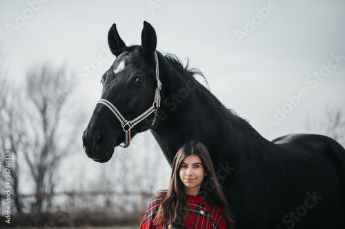 Girl with a horse at the stables