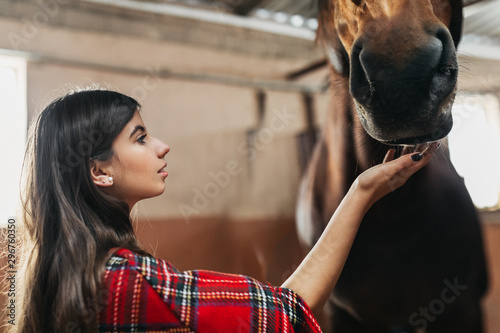 Girl embraces her pet horse © Suteren Studio