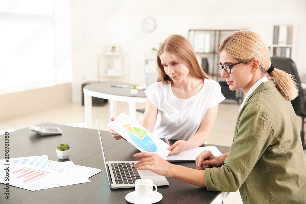 Beautiful businesswoman and her colleague discussing issue in office Beautiful businesswoman and her colleague discussing issue in office