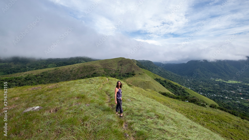 Female hiker walking on top of India Dormida mountain at El Valle de Aton, Panama
