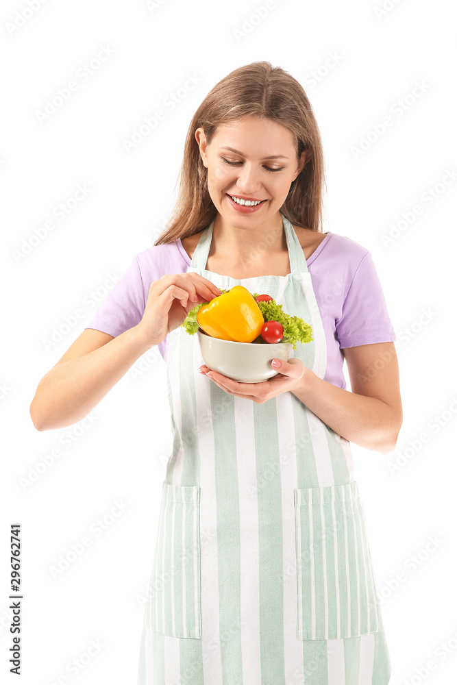 Beautiful young woman in apron and with vegetables on white background Beautiful young woman in apron and with vegetables on white background