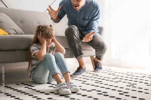 Angry father scolding his l...