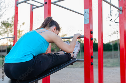 Young woman stretching in an outdoor training park