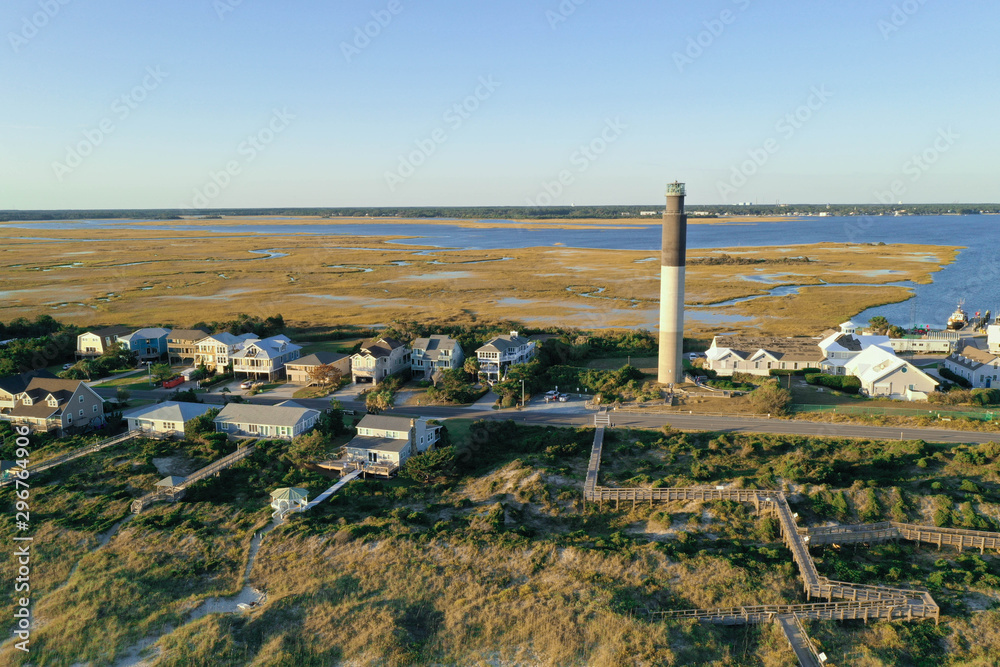 Aerial view of Oak Island Light house in North Carolina. The inter coastal waterway and marsh is in the background.