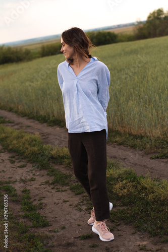 Happy Young Woman  in a linen shirt In A Field 