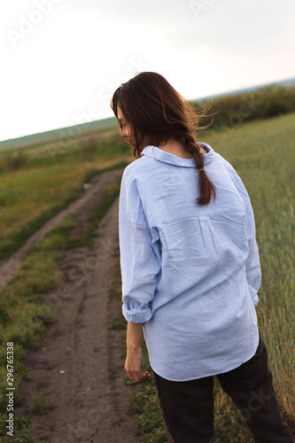 Happy Young Woman  in a linen shirt In A Field 