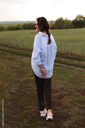 Happy Young Woman  in a linen shirt In A Field 