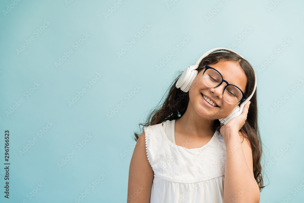 Female Child With Long Brown Hair Enjoying Music Female Child With Long Brown Hair Enjoying Music