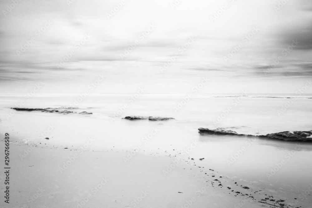 Several rocks on the beach. Coastal landscape. Lonely landscape by the sea.