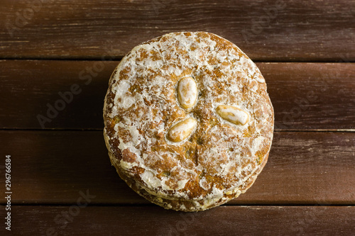 Traditional German Austrian Swiss Christmas holiday pastry specialty glazed gingerbread cookies Lebkichen with spices nuts stacked on aged wood table. Rustic cozy atmosphere photo