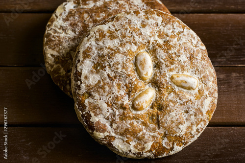 Traditional German Austrian Swiss Christmas holiday pastry specialty glazed gingerbread cookies Lebkichen with spices nuts stacked on weathered wood table. Rustic cozy atmosphere photo