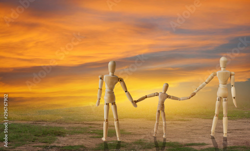 Three wooden puppet against the golden sky background