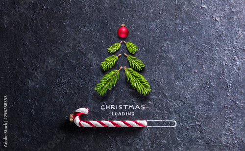 Christmas Card - Loading Concept - Tree And Candy Canes On Black Stone photo