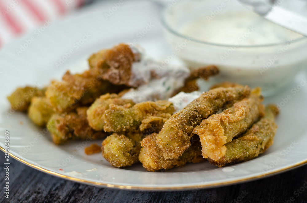 The crispy fried okra in container and spicy yogurt sauce The crispy fried okra in container and spicy yogurt sauce