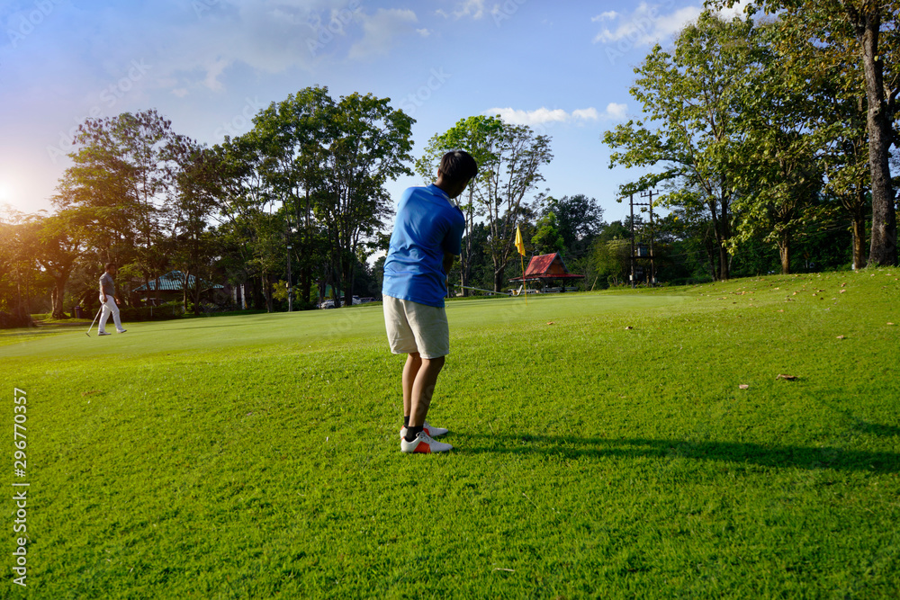 Golfer playing golf in beautiful golf course in the evening golf course Golfer playing golf in beautiful golf course in the evening golf course